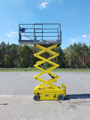 Yellow lift self-propelled platform in the parking lot.